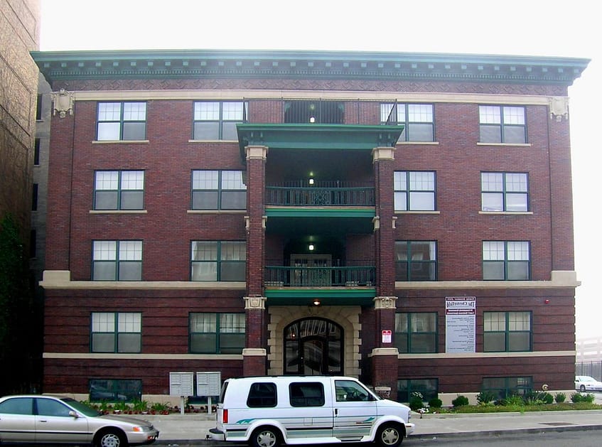 apartment building with cars outside of it